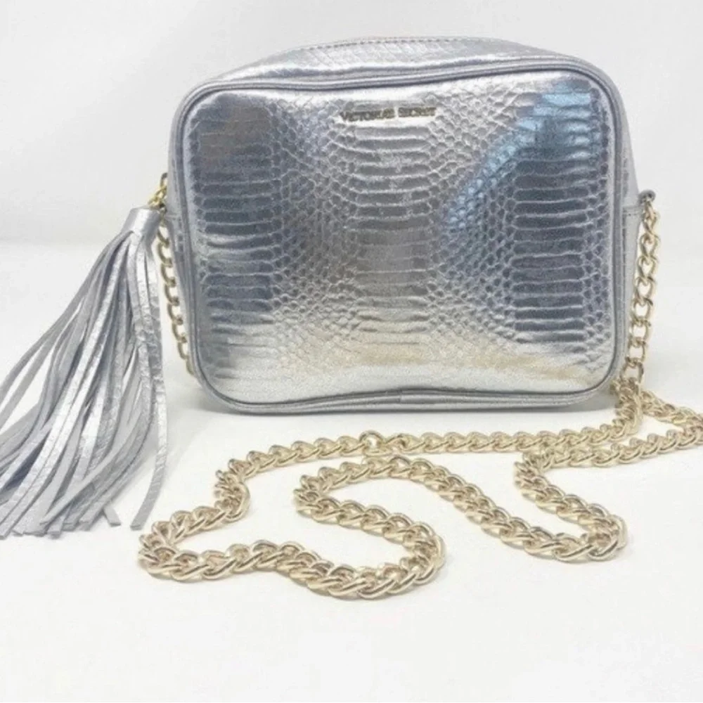 Victoria’s Secret silver snake skin purse with gold chain strap.